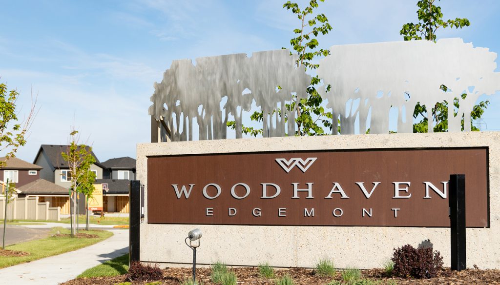 Woodhaven sign with houses in background.